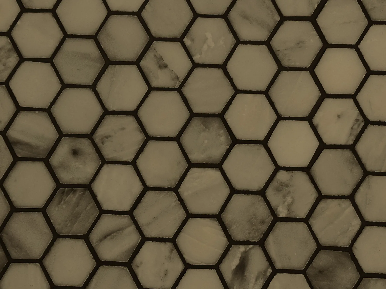 Hexagon mosaic tile with grout lines, before cleaning