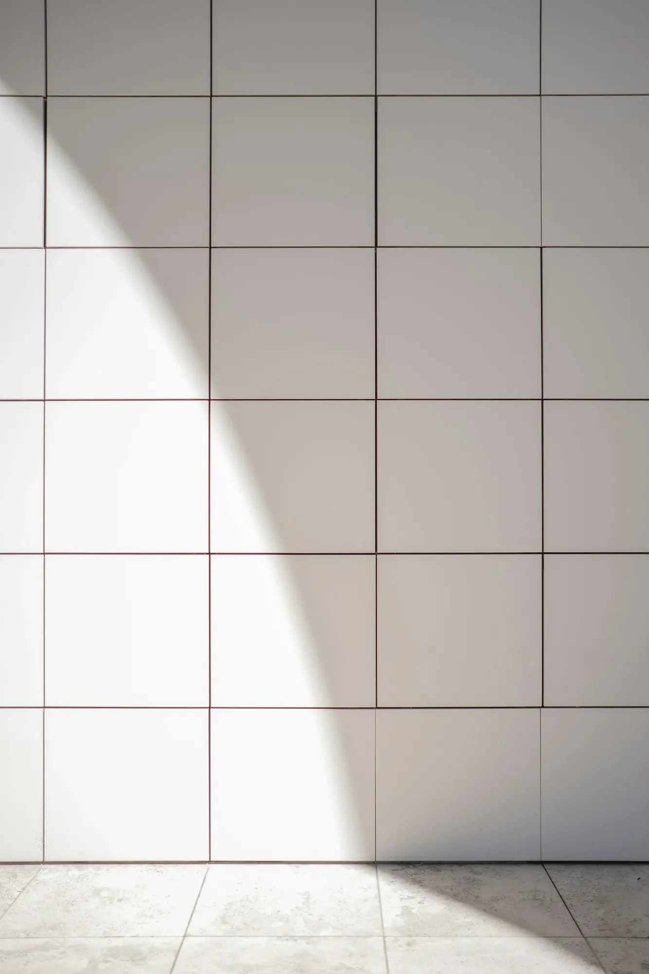 Clean white tile and grout lines in soft daylight